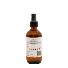 Second Nature Botanicals room spray bottle, amber glass with pump, back label visible