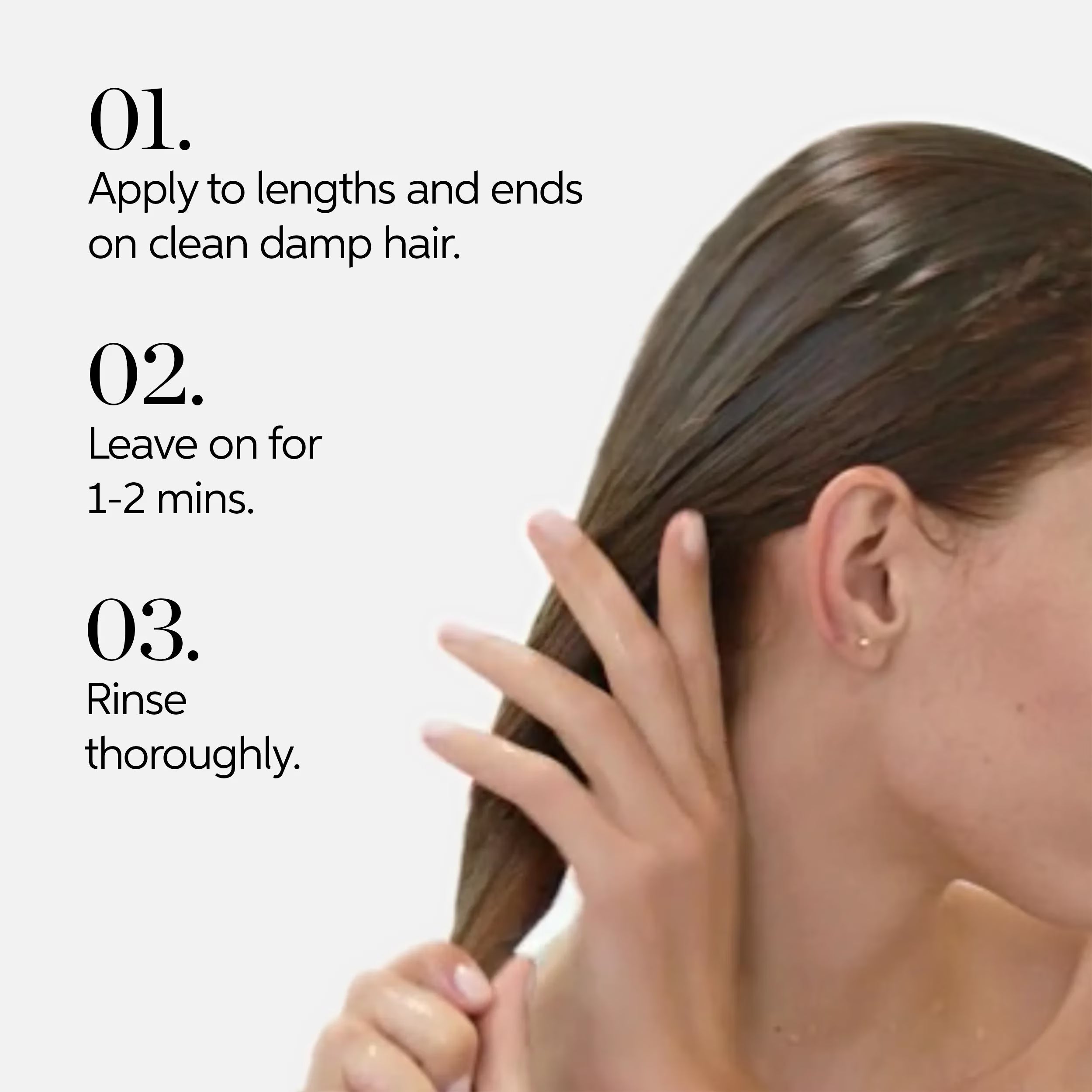 Conditioner application: hands smoothing hair on a clean damp head
