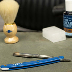 Cut-throat straight razor with blue handle and open blade
