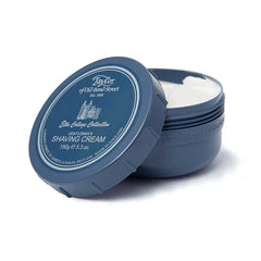 Shaving cream bowl with blue lid open, white cream visible in container