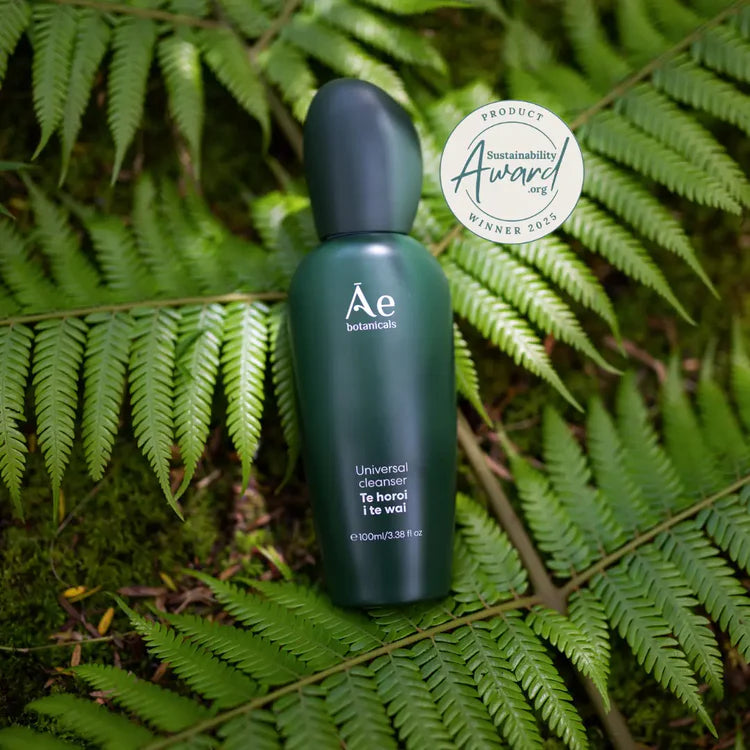 Universal cleanser bottle, dark green bottle with cap and sustainability badge sticker.