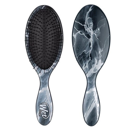 Oval paddle hair brush set with dark bristles and marble-effect handle, onyx style.