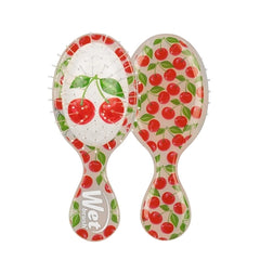 Mini detangling hair brush with cherry pattern, white red and green handle
