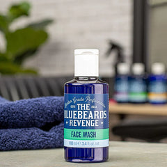 Face wash bottle with blue transparent body, white pump-style cap, green front label