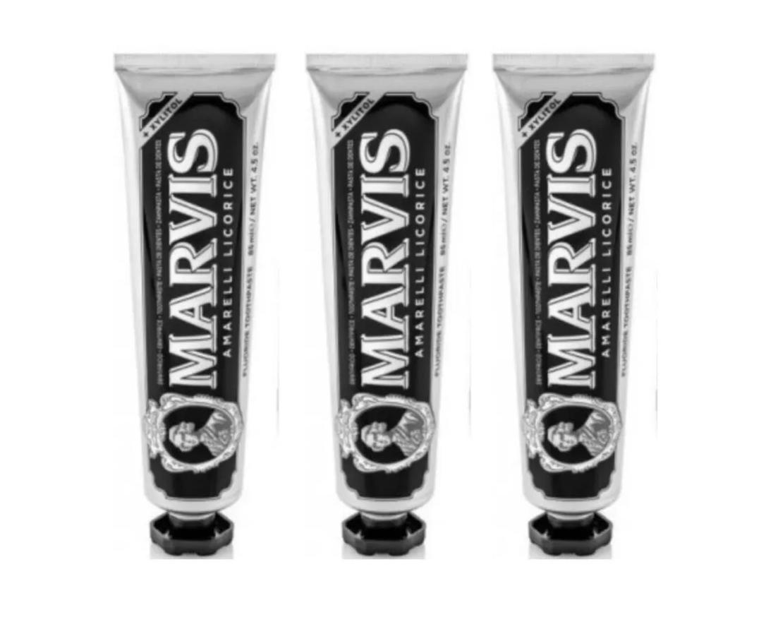 Marvis licorice mint toothpaste set with three tubes, black cap and white body.