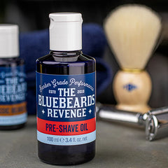 Pre-shave oil bottle with blue label and white cap, 100 ml