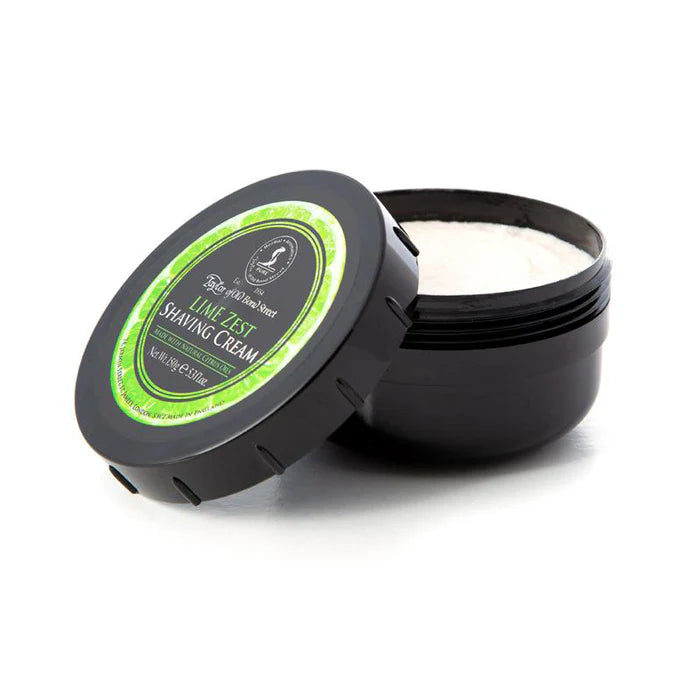 Shaving cream bowl open, white cream inside, black base with lime zest label